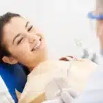 young woman receiving dental check up 150x150 1