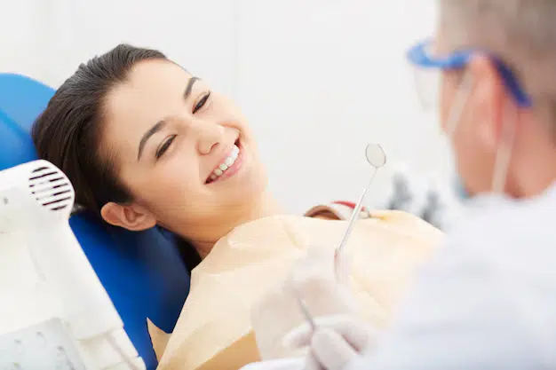 young woman receiving dental check up 1098 1512